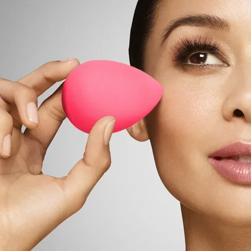 girl blending with a basic beauty blender with mastering skills of perfect makeup